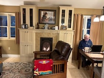 Living Room/Dining with great chair by fireplace