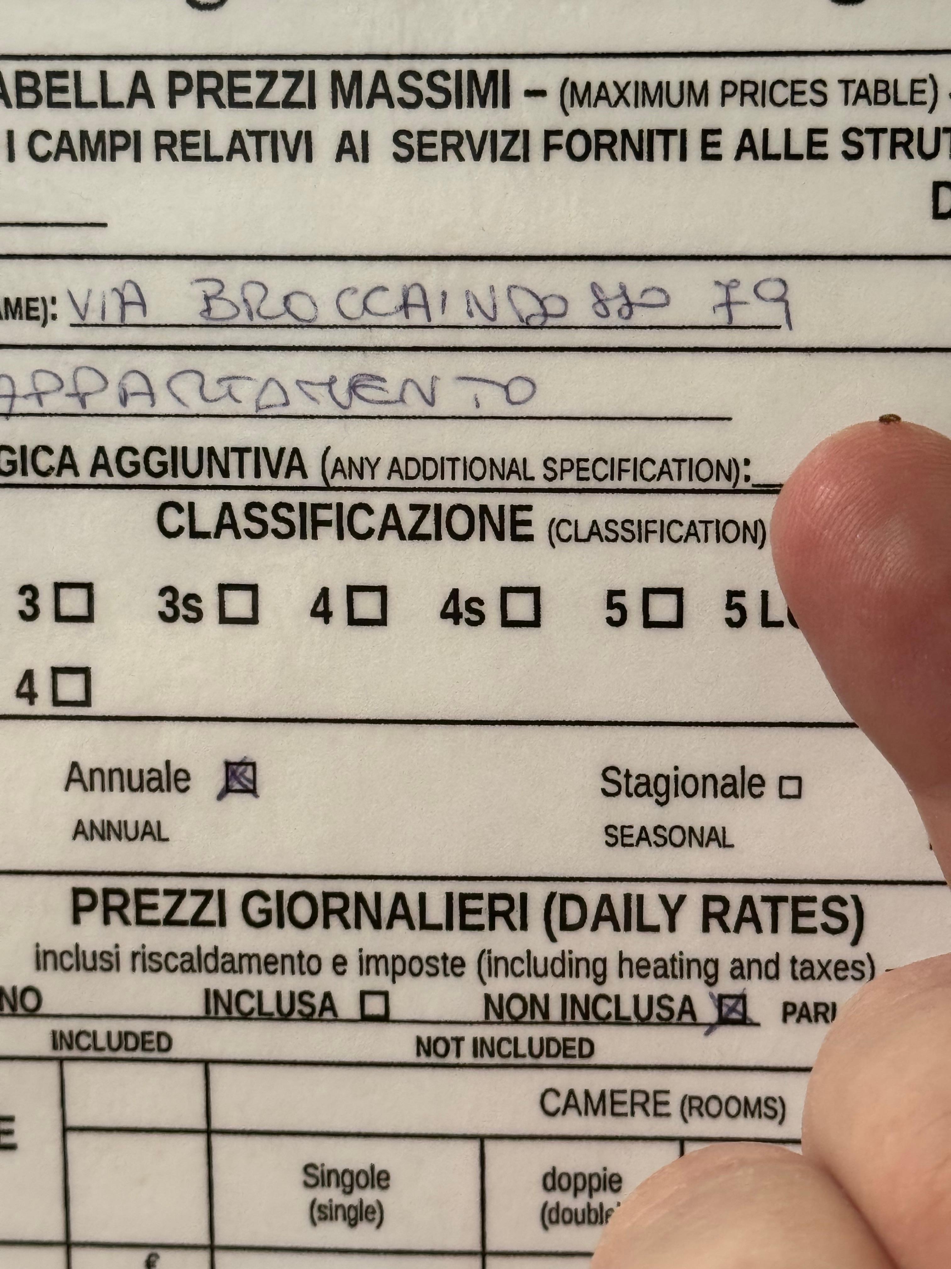 Apparent bed bug/flea on finger juxtaposed with address card on entry door (2:23 AM CEST May 3)