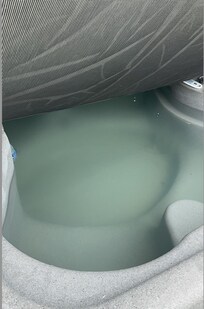 The cloudy and dirty water in the hot tub