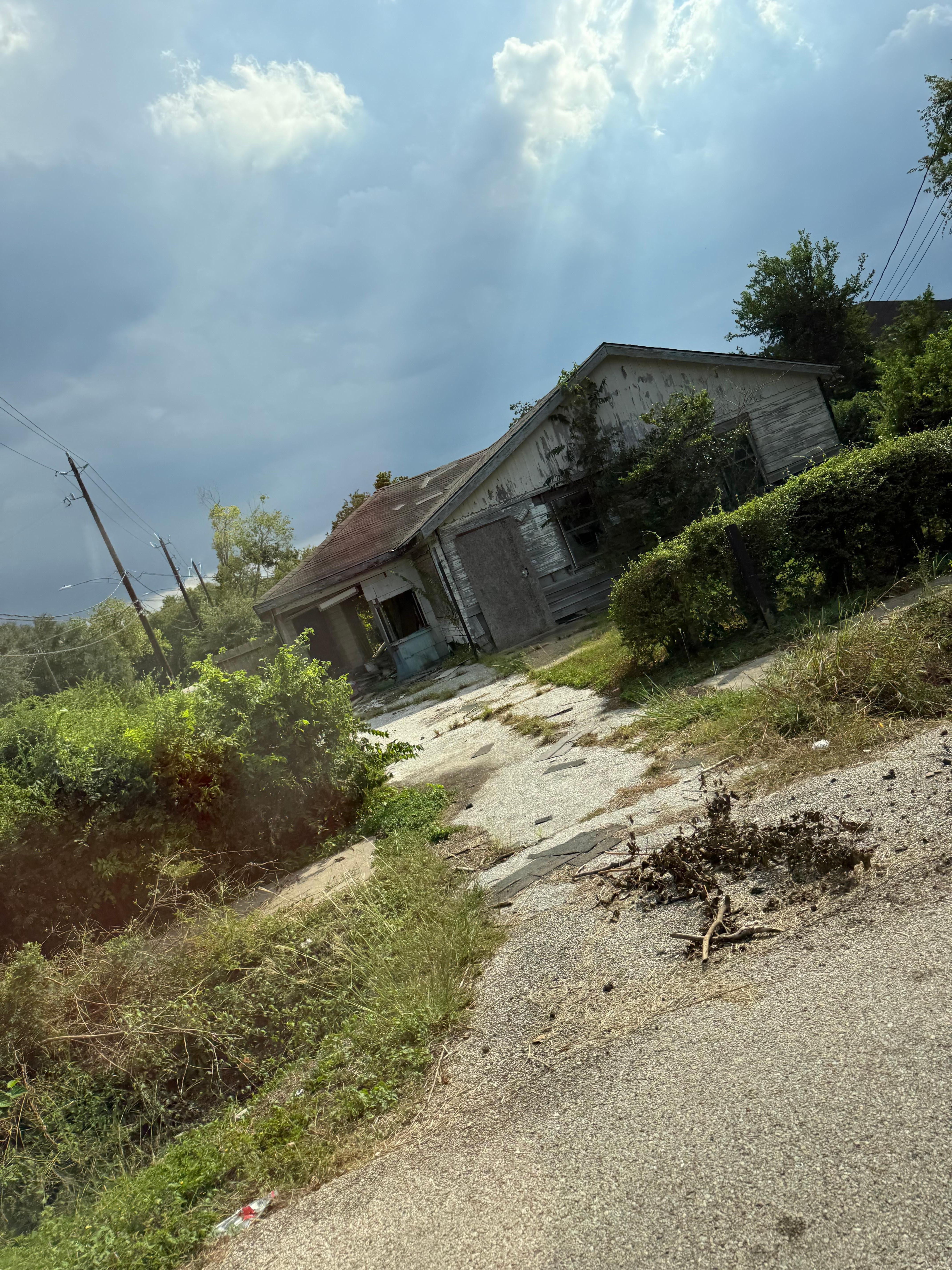 Directly across the street, condemned house with homeless hiding in back yard. 