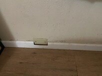 Dirt all around baseboards and floor