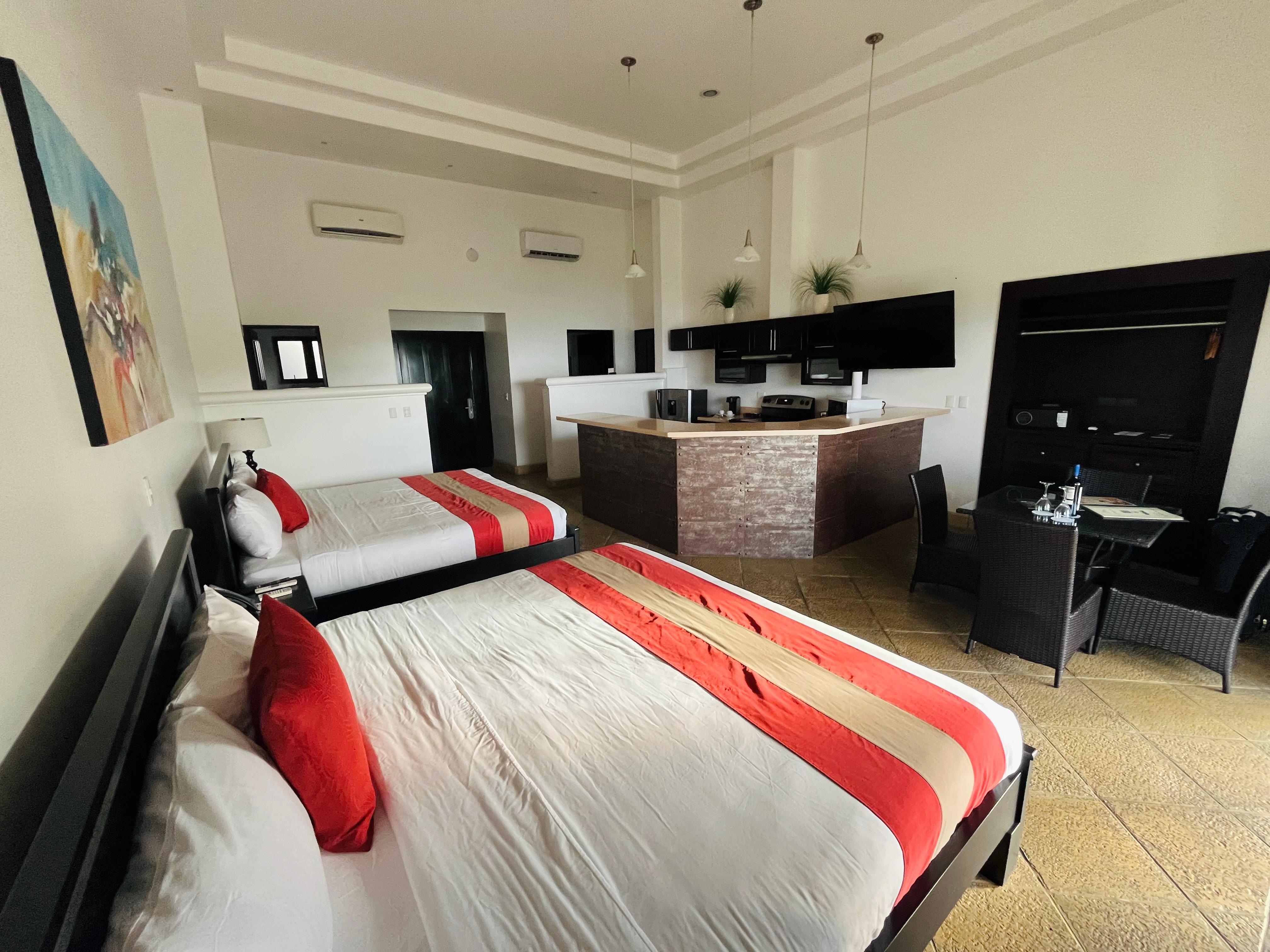 Our room and kitchen with sink, stove, and apartment-size fridge