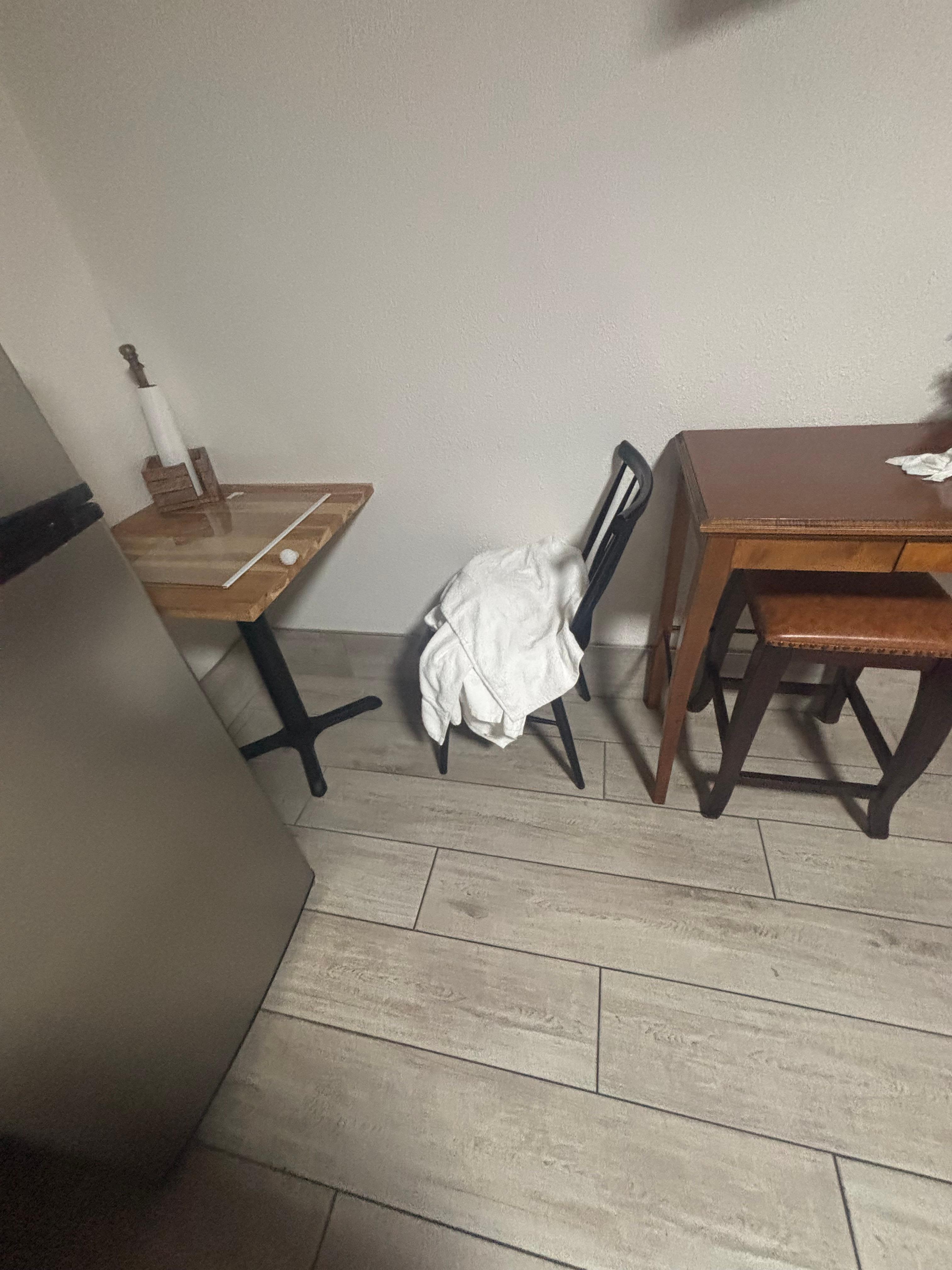 Dirty towels and piece of the refrigerator left out on the table