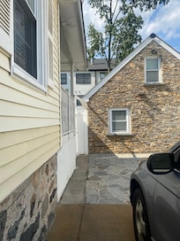 White gate on the left is the entrance through the back. Washer/dryer shared with stone apartment directly ahead and the machines are located behind this separate unit.