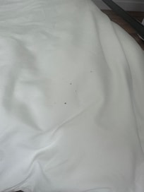 One bed with stained sheets