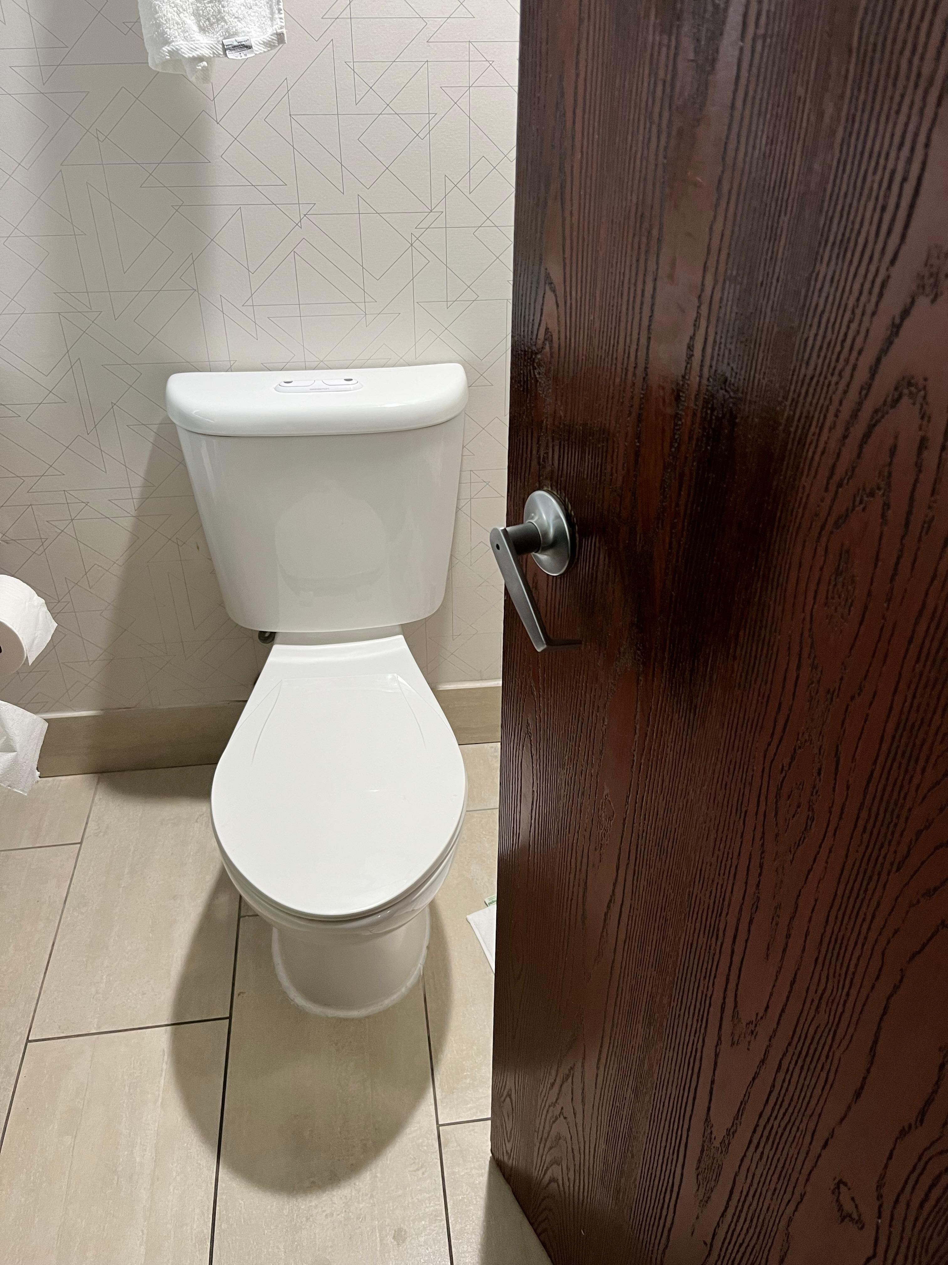 Door opens right in front of the toilet. There is no clearance. You’ll smack someone with the door, or be trapped trying to get out.