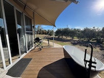 Outdoor patio with BBQ and bathtub