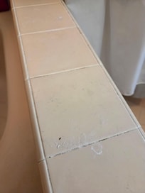 Tub edge not cleaned.