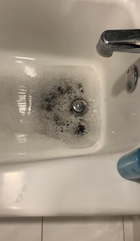 Black debris after bathing in bathtub came up from drain… and smelled