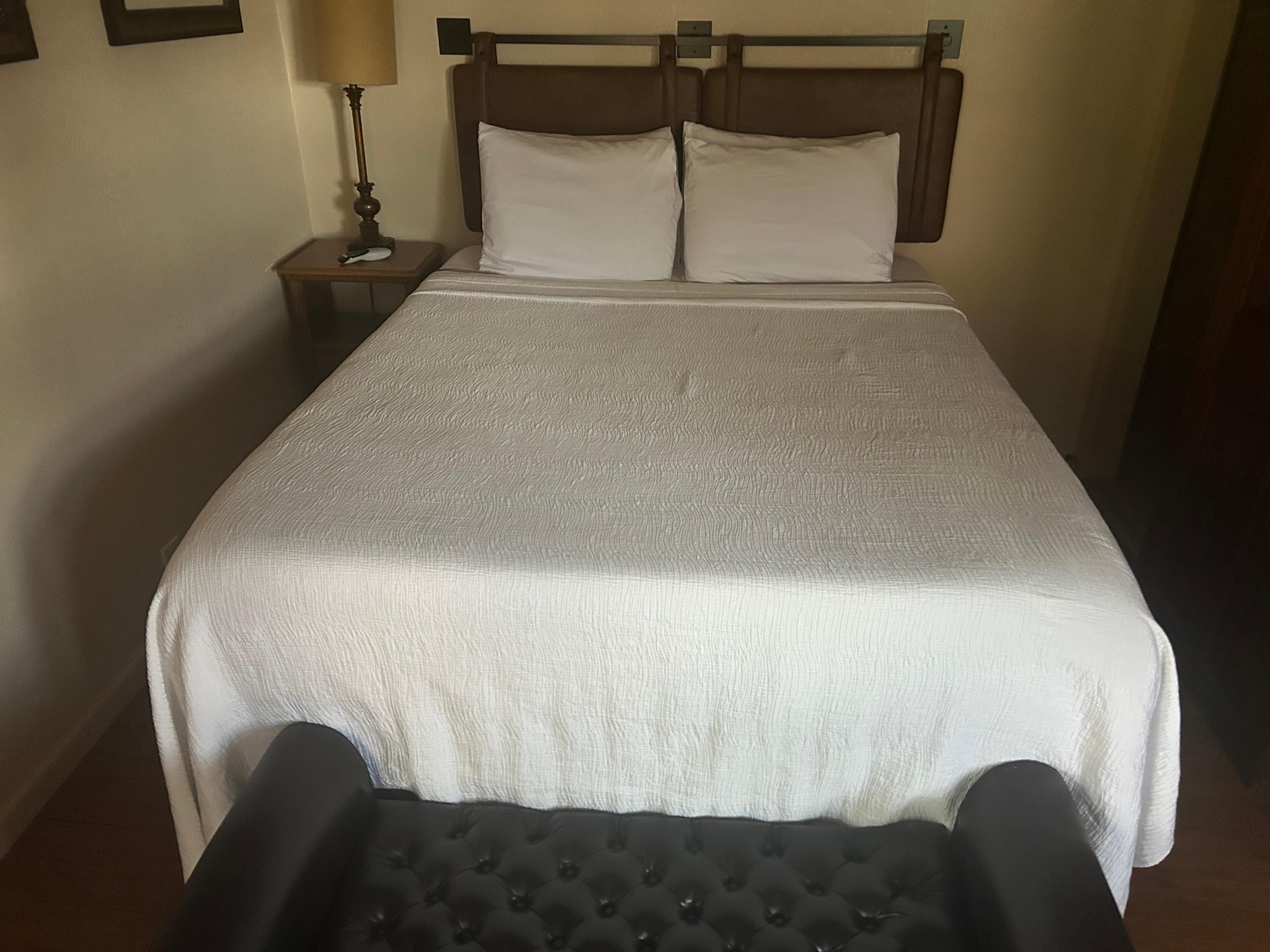 Bed and leather tuck-and-roll box