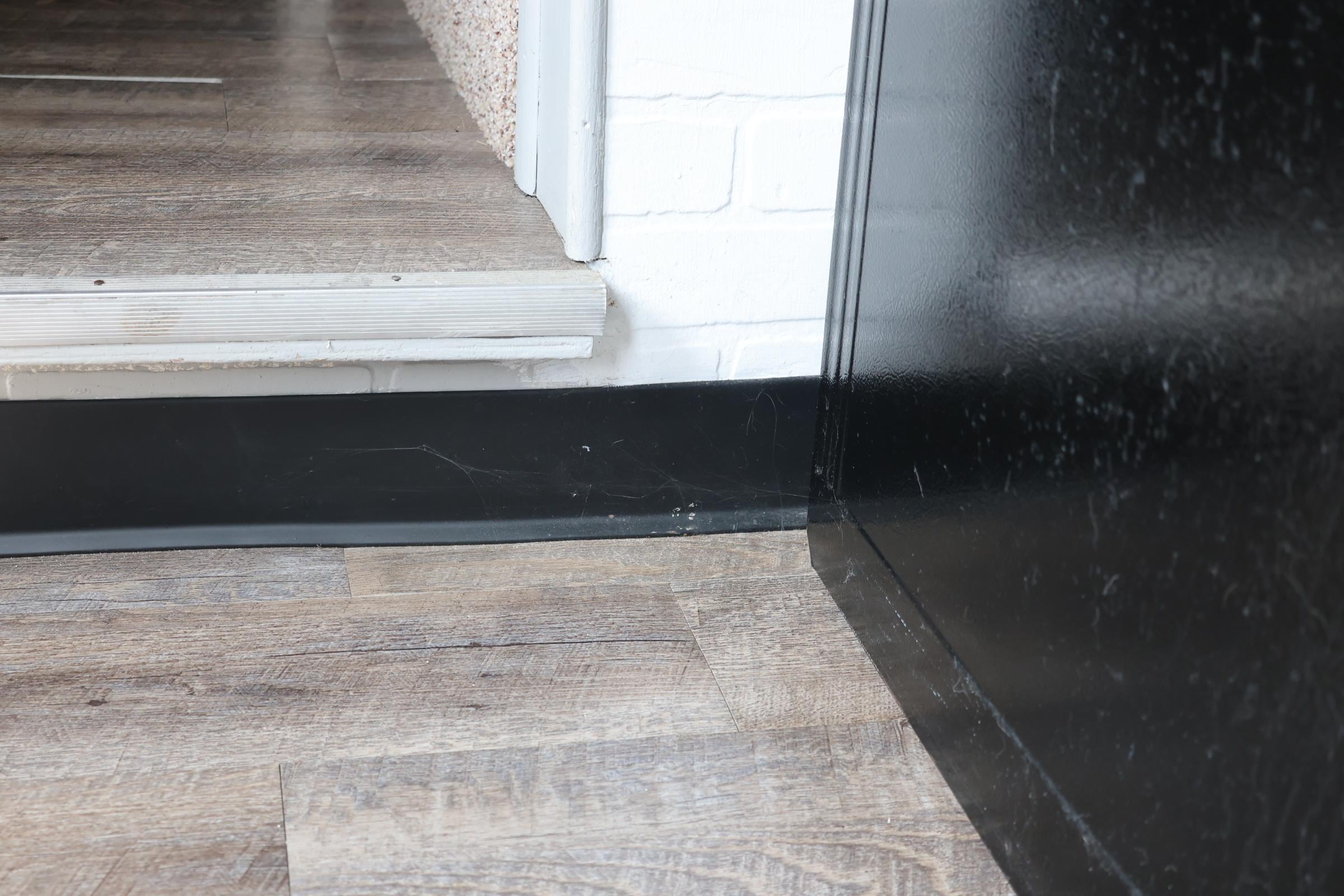 Spider webs inside the house near the kitchen on the stair