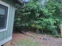 This is a back yard with fallen fence. It doesn't look very picturesque.