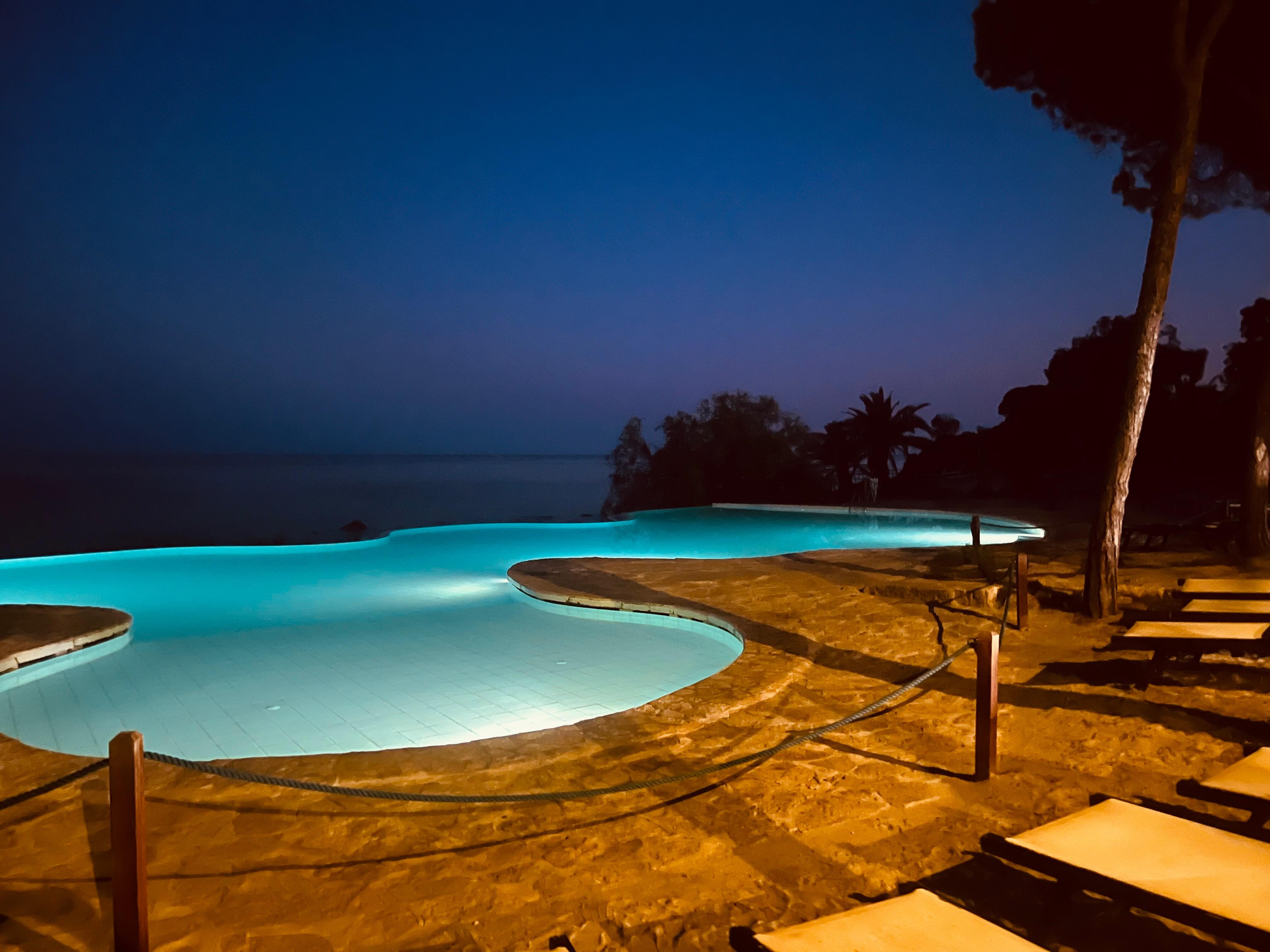 Pool by the sea at night 