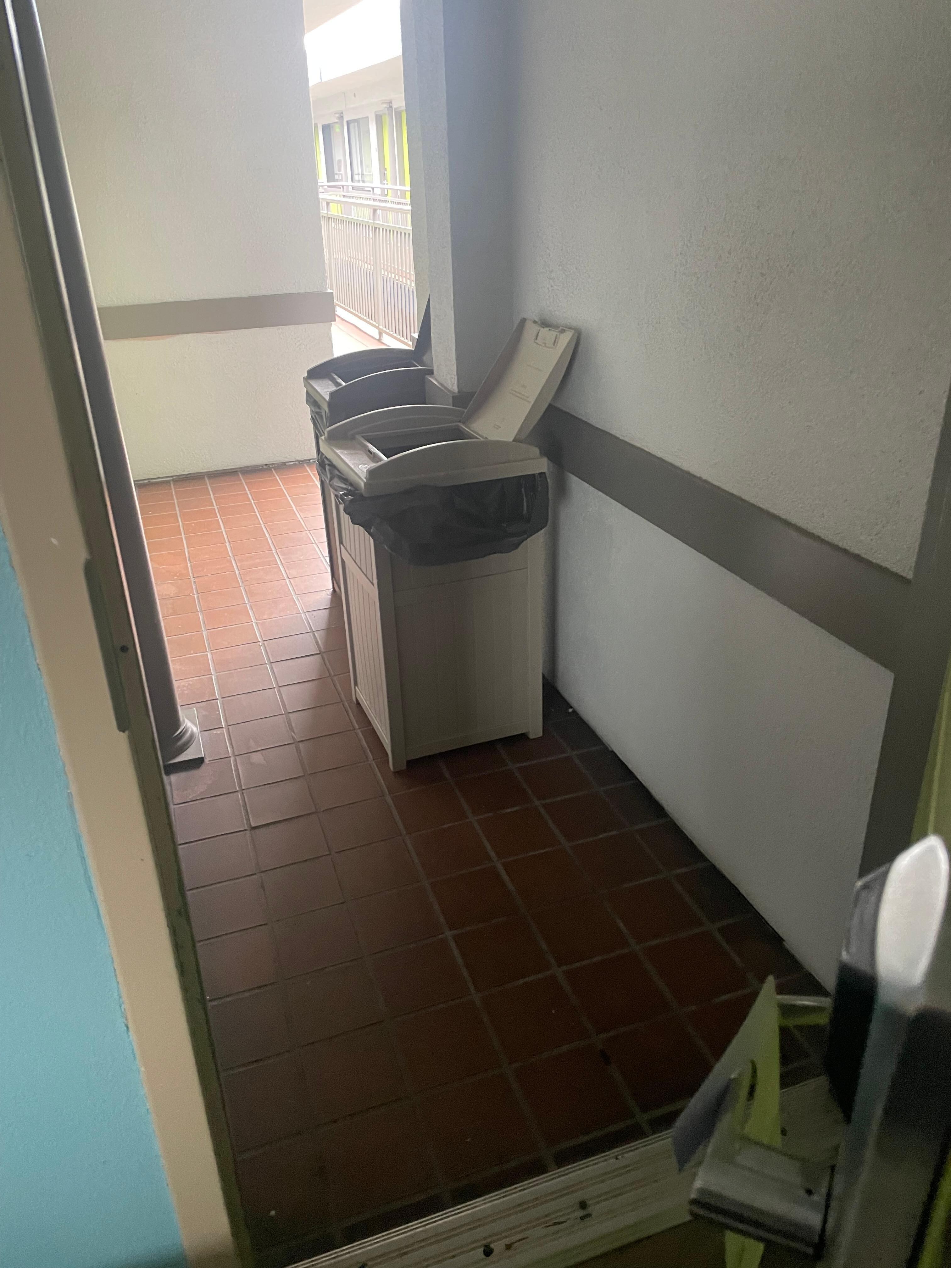 open garbage cans blocking the entryway to my room. 