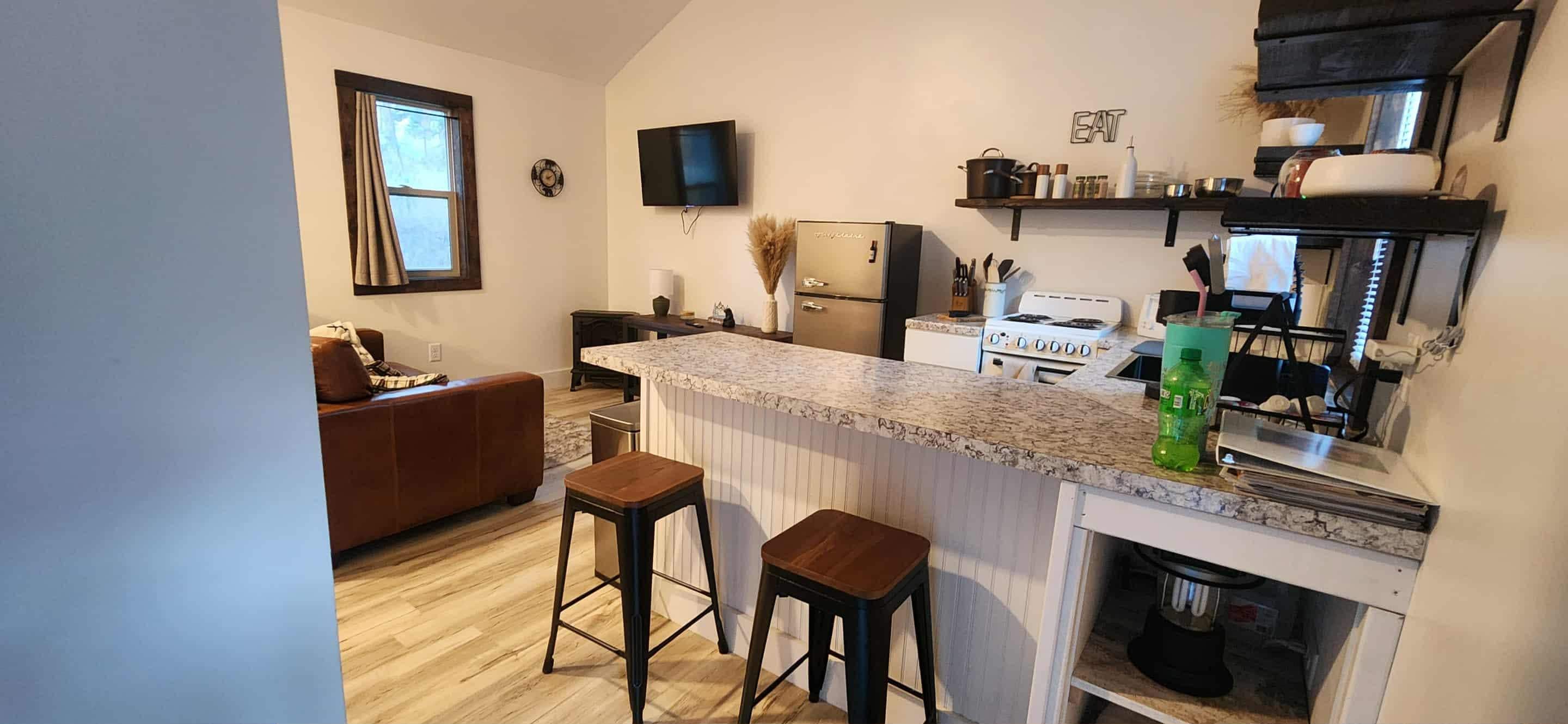 Kitchen area with living room in the background