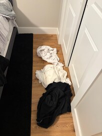 Someone’s clothes beside the bed