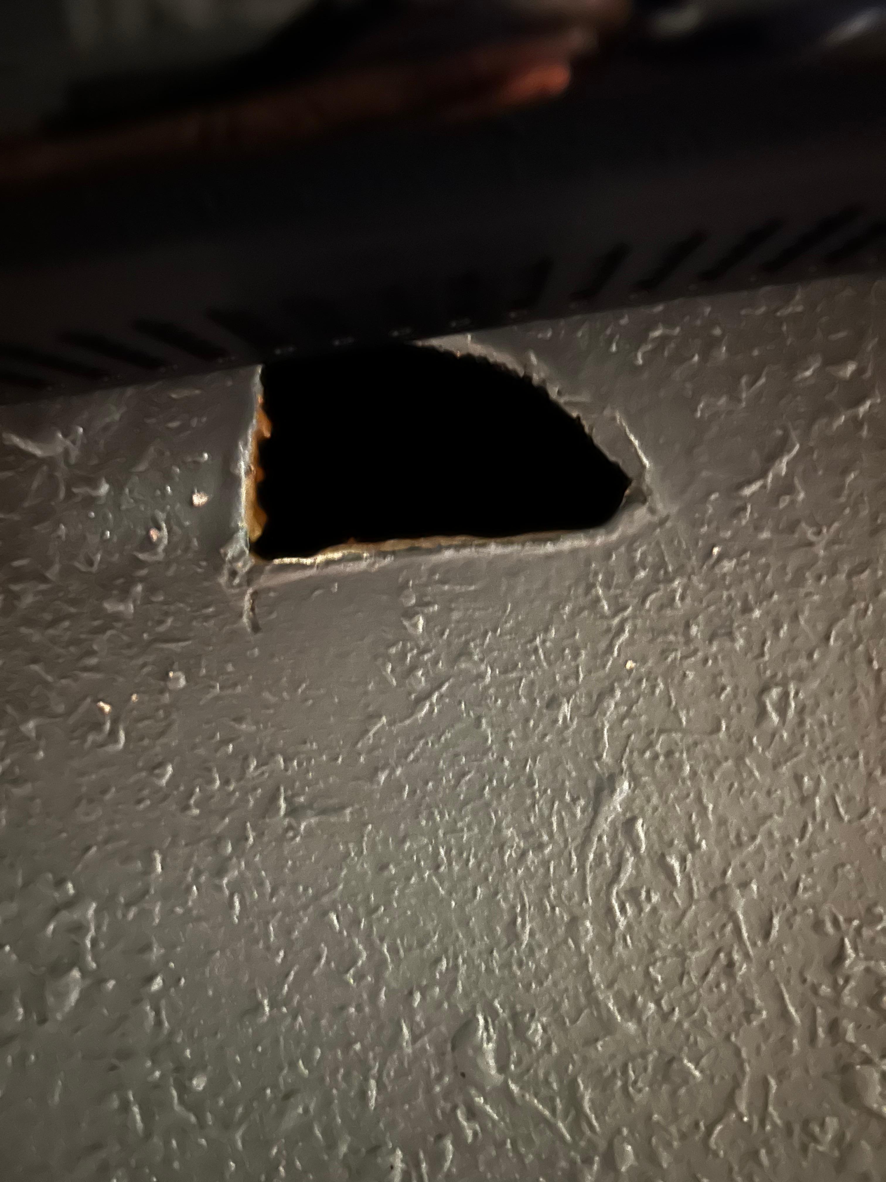 Hole in wall under tv. 