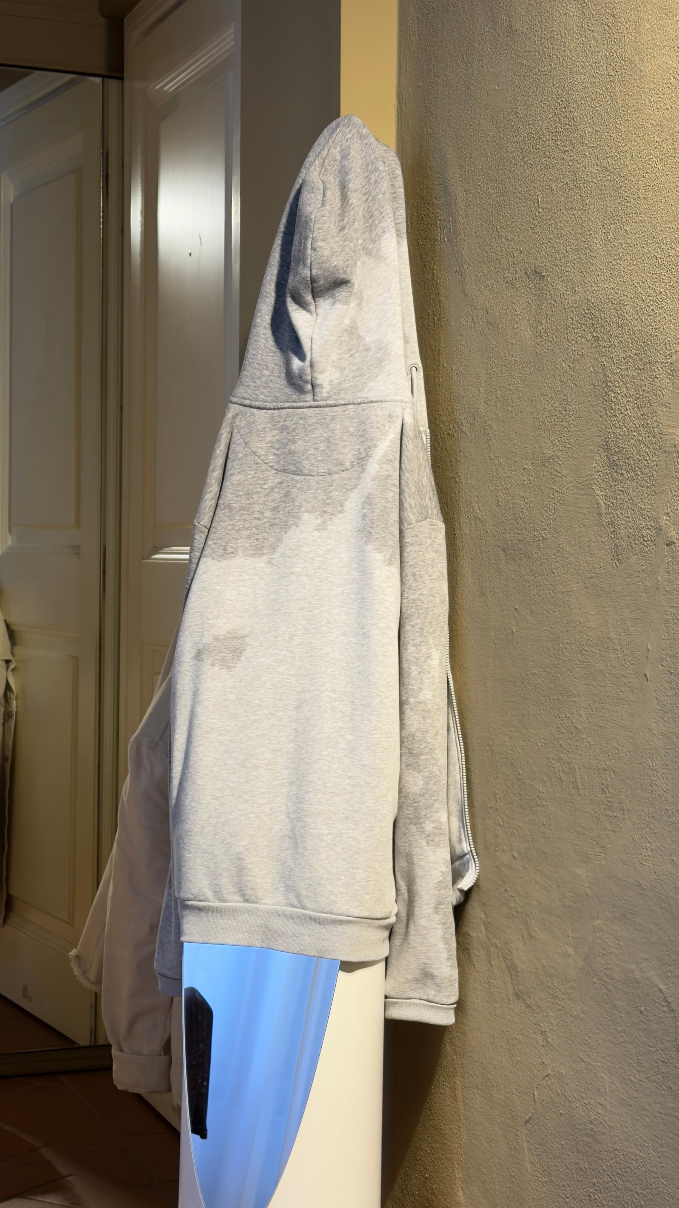 Soaked clothes drying on a mirror