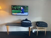 Only a table and a chair by the TV with no dresser or drawers for storage. The only drawers were in the small single nightstand between the double beds.