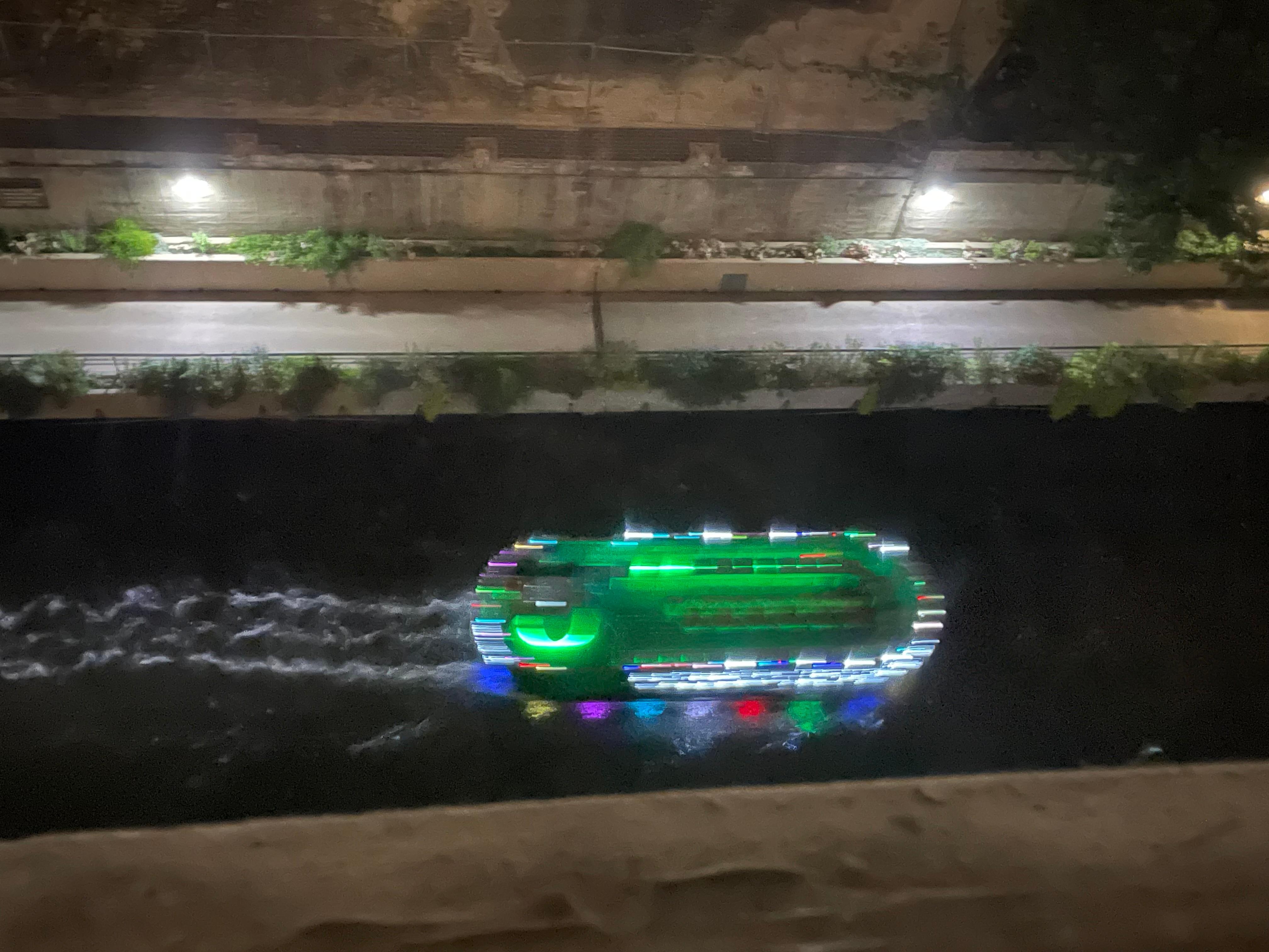 A river pontoon boat going by directly down from my window overlooking the river