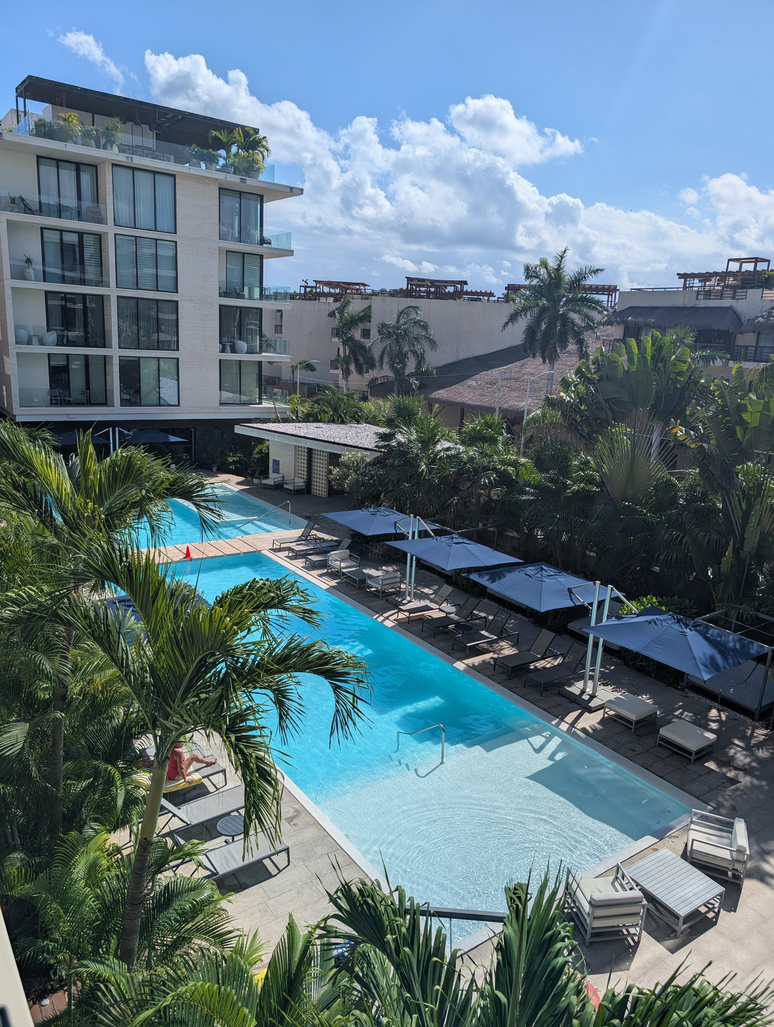 Pool area with ample, comfortable seating and umbrellas