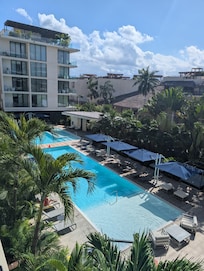 Pool area with ample, comfortable seating and umbrellas