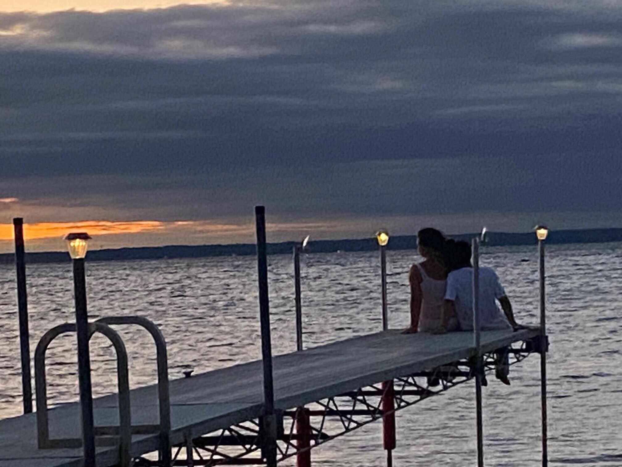 Grandkids watching the sunset at the end of the dock