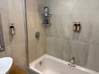 Shower with no door or curtain.