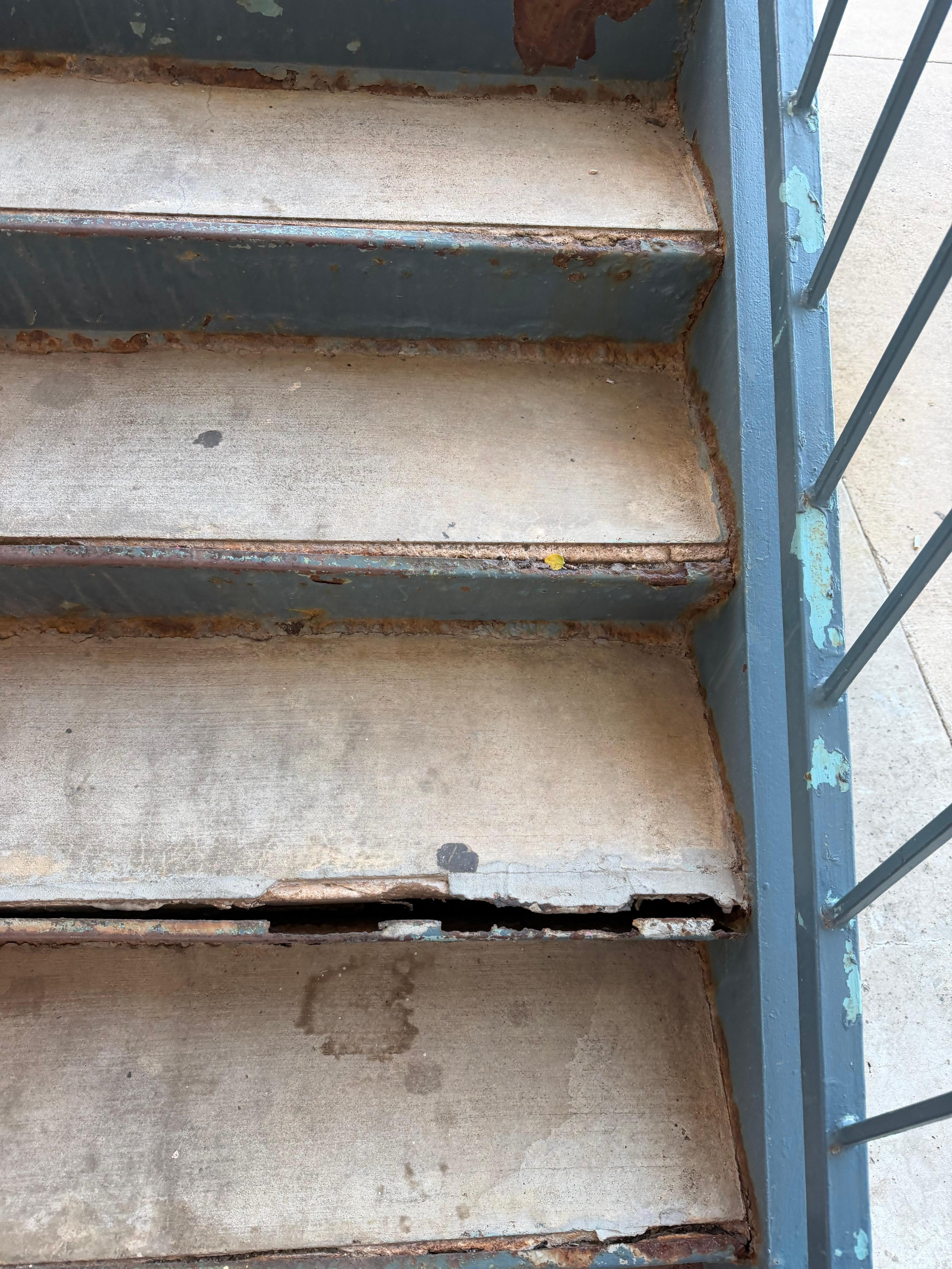 Broken stairs but other stairwell taped off due to broken done