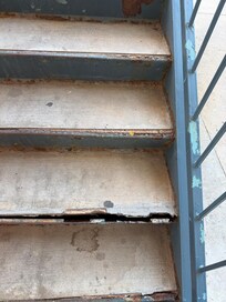 Broken stairs but other stairwell taped off due to broken done