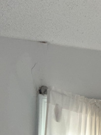 Water damage by windows in the living room.