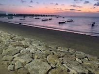 stroll along Pantai Jerman at sunset and watch the planes