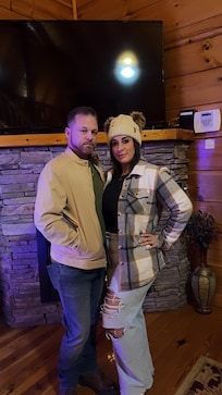 Me and wife by the Christmas tree in the cabin