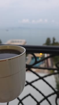 Morning cup of coffee on room's balcony