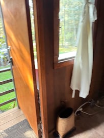 Front door to entry way “bedroom” with futon