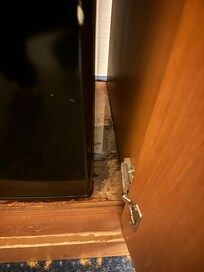 Leaking mini fridge with mold and water damage.