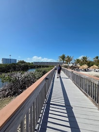 Walkway at beach with 2 condo units in background.