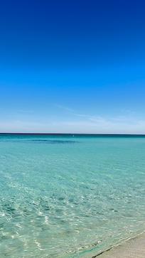 Crystal clear and dynamically blue water in front of our beach chairs