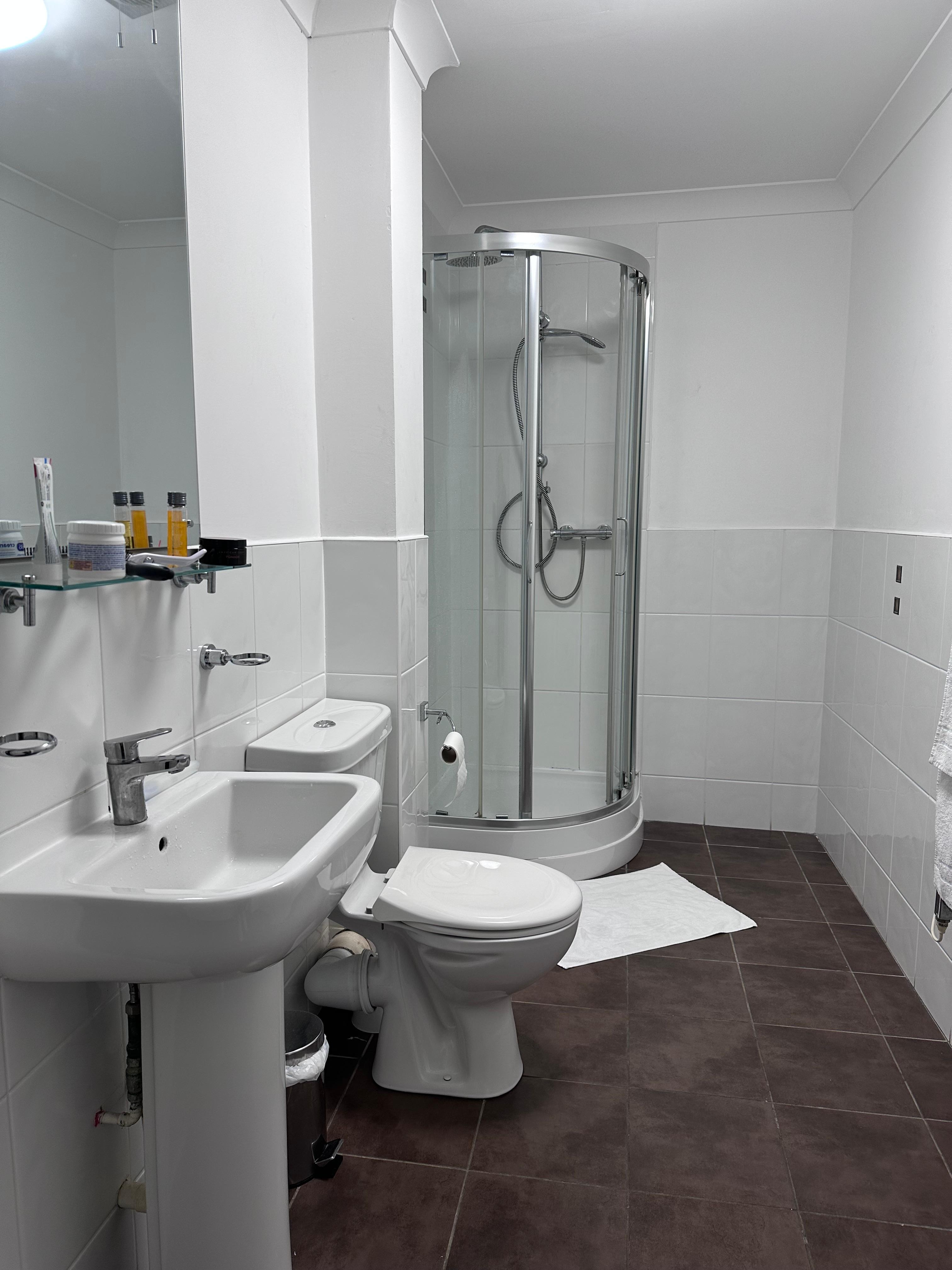 Long spacious bathroom but a tiny shower cubicle 