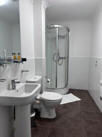 Long spacious bathroom but a tiny shower cubicle