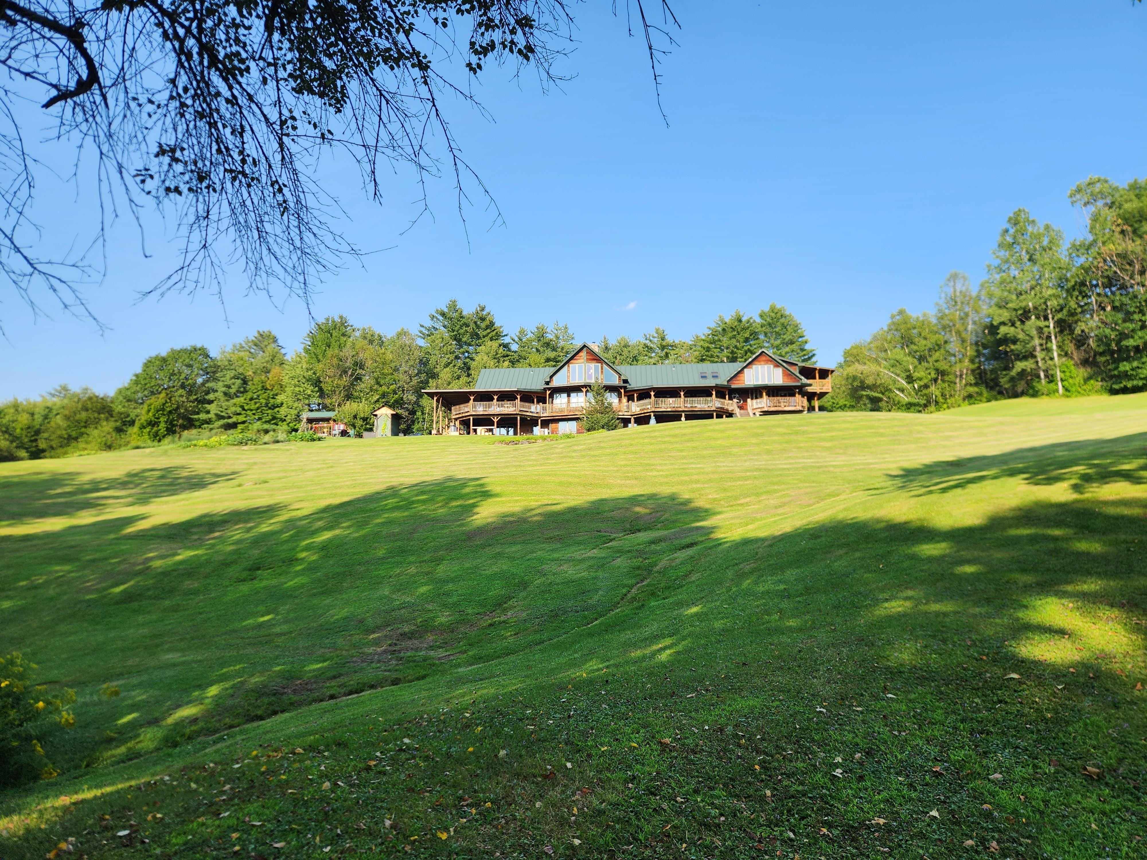 Located atop a beautiful hill surrounded by forest and mountains in the distance.