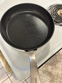 The pan was fine after it was heavily scrubbed. So, it just wasn’t washed properly before it was put away.