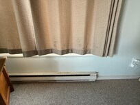Moldy curtains and rusty baseboard