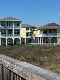 View of the house from the boardwalk. Itâs the yellow house in the middle.