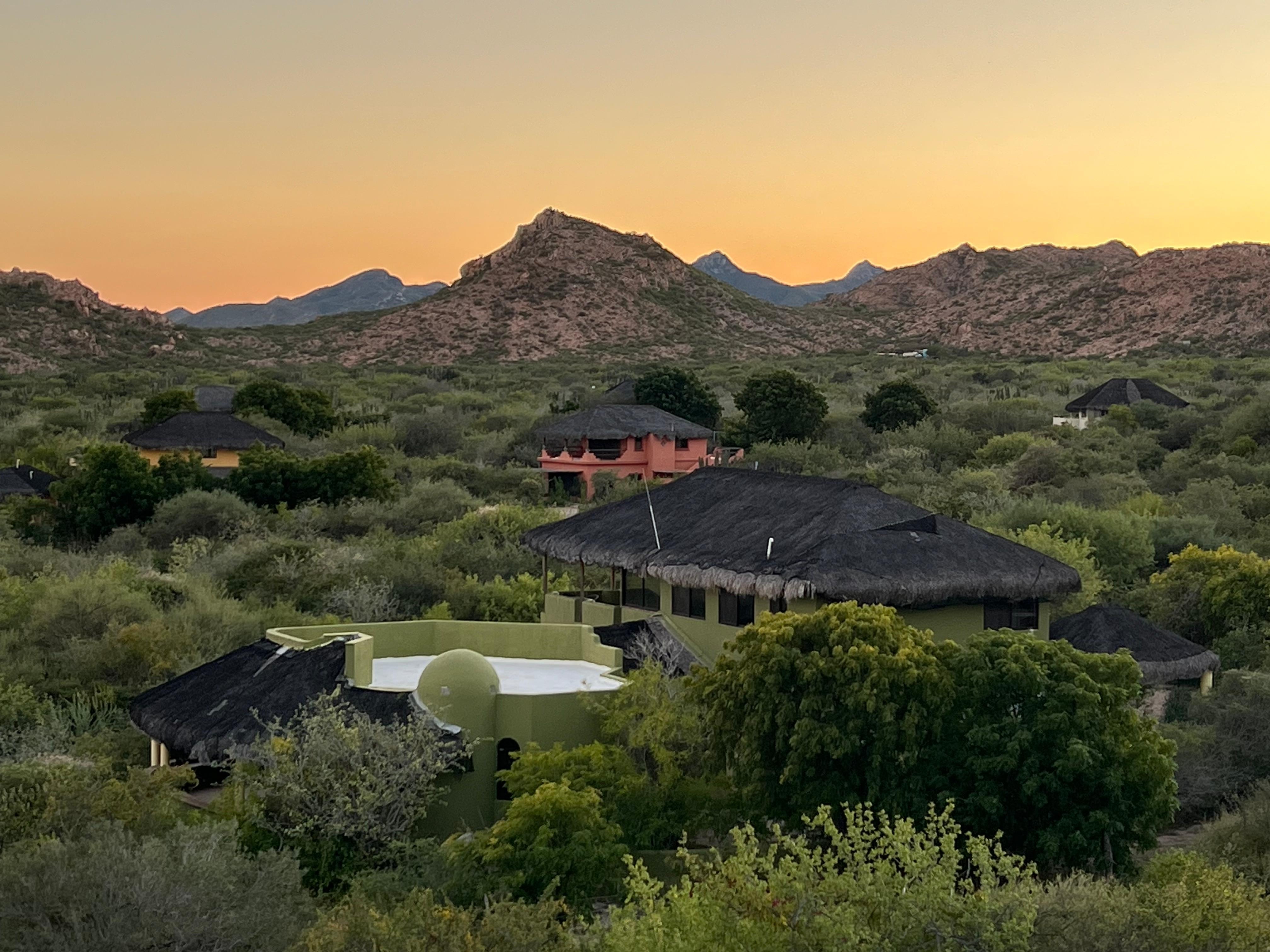 view of neighborhood from outdoor kitchen/patio includes view of sea
