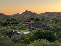 view of neighborhood from outdoor kitchen/patio includes view of sea