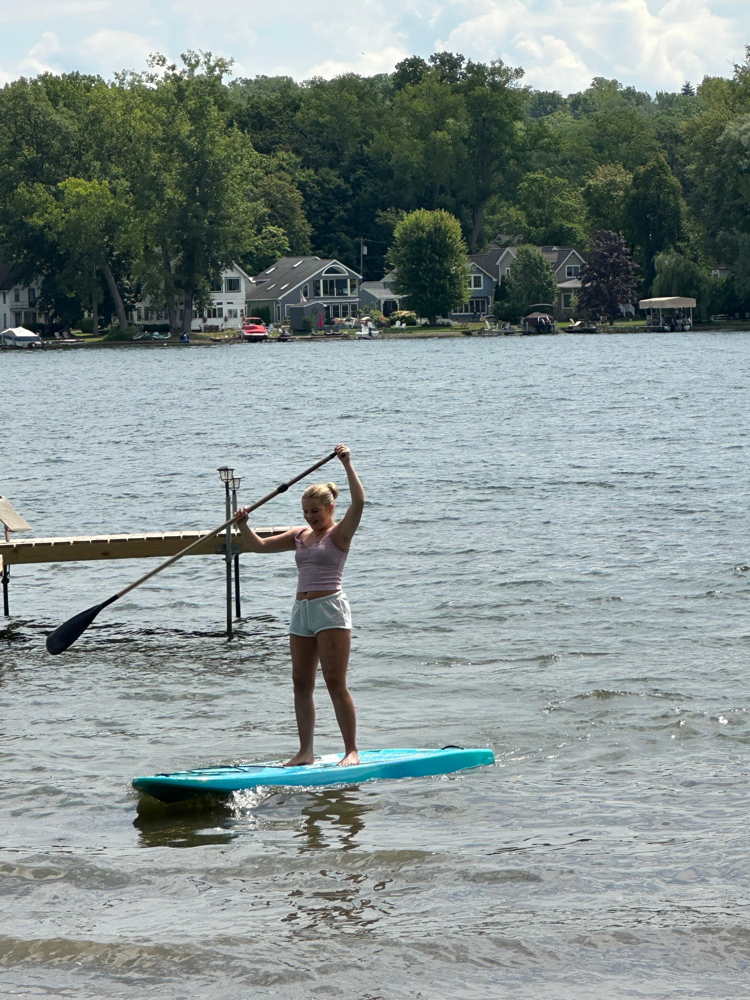 Granddaughter paddle boarding.