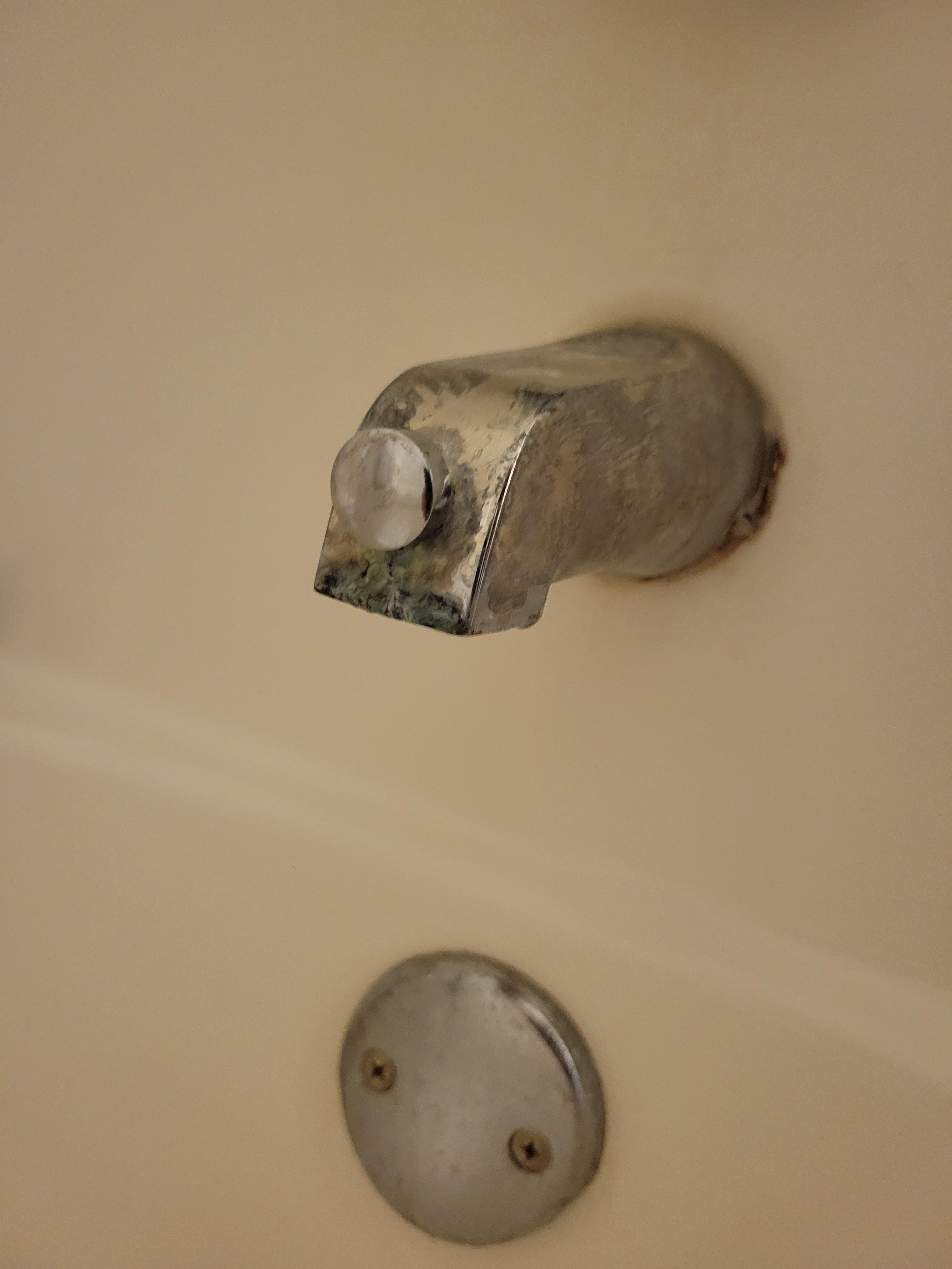 Tub faucet dirty, corroded and dripping.