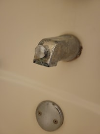 Tub faucet dirty, corroded and dripping.