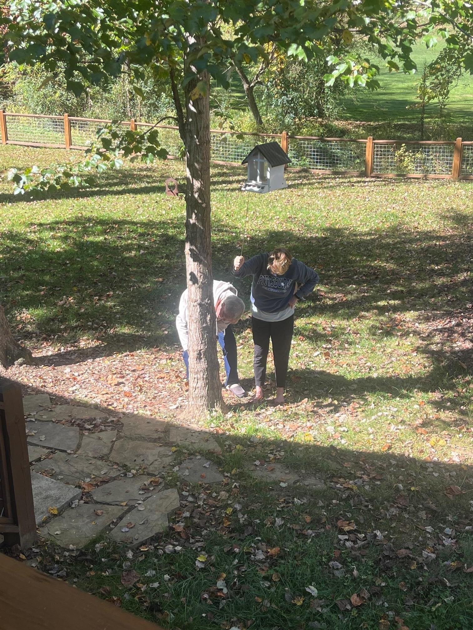 Securing the bird feeder after filling it up